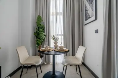 a dining room with a table and two chairs at GuestReady - Urban retreat at 15 Northside in Dubai