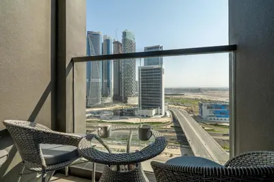 a balcony with two chairs and a view of a city at GuestReady - Urban retreat at 15 Northside in Dubai