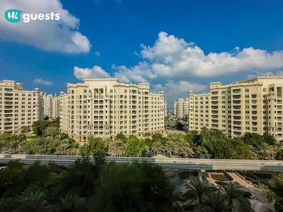 a group of large white buildings in a city at Higuests - Luxurious 2BR Haven in Iconic Palm Jumeirah in Dubai