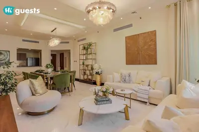 a living room with couches and a dining room at Higuests - Luxurious 2BR Haven in Iconic Palm Jumeirah in Dubai