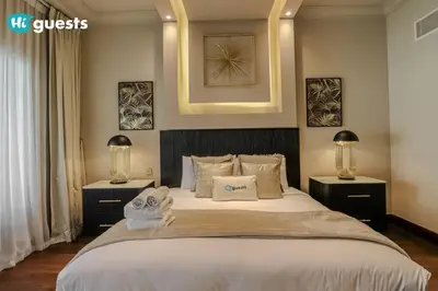 a bedroom with a large white bed with two night stands at Higuests - Luxurious 2BR Haven in Iconic Palm Jumeirah in Dubai
