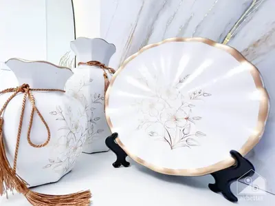 a plate and two vases on a shelf at Luxury Living in Azizi Riviera & Cozy Balcony in Dubai