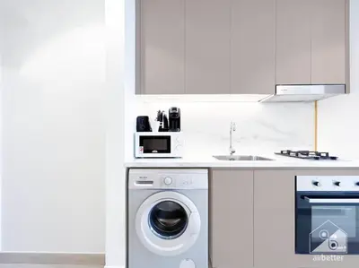 a kitchen with a washing machine and a sink at Luxury Living in Azizi Riviera & Cozy Balcony in Dubai