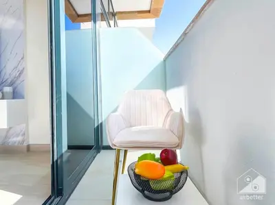 a chair and a bowl of fruit in a room at Luxury Living in Azizi Riviera & Cozy Balcony in Dubai