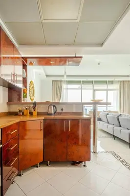 a kitchen with a sink and a couch in a room at Elegant 2BR Apartment in the Heart of Marina in Dubai