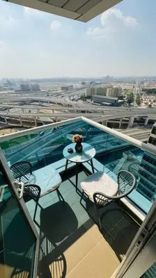 a balcony with a table and chairs on a building at Elegant 2BR Apartment in the Heart of Marina in Dubai
