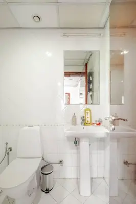 a white bathroom with a toilet and a sink at Elegant 2BR Apartment in the Heart of Marina in Dubai