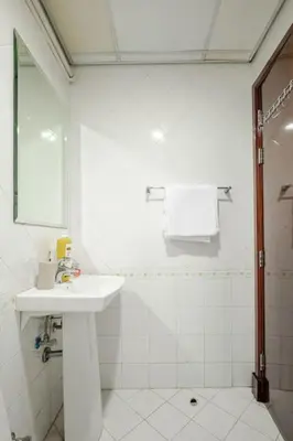a white bathroom with a sink and a shower at Elegant 2BR Apartment in the Heart of Marina in Dubai