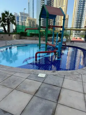 a swimming pool with a playground in a city at Bel appartement Dubai marina in Dubai