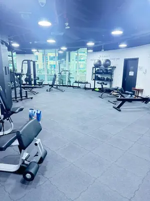 a gym with a lot of exercise equipment in a room at Bel appartement Dubai marina in Dubai