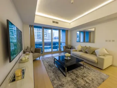 a living room with a couch and a table at Bel appartement Dubai marina in Dubai