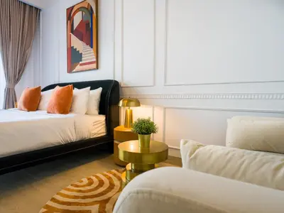 a bedroom with a bed and a couch and a table at EasyGo - Modern STU- Luma22- JVC in Dubai