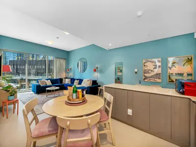 a living room with a table and a couch at Premium 1 BDR, In Burj Khalifa Park, Dubai Mall Walking Distance , Opera House 1mn away in Dubai