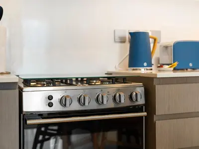 a kitchen with a stove top oven in a kitchen at Premium 1 BDR, In Burj Khalifa Park, Dubai Mall Walking Distance , Opera House 1mn away in Dubai