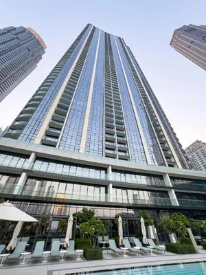 a tall building with a pool in front of it at Premium 1 BDR, In Burj Khalifa Park, Dubai Mall Walking Distance , Opera House 1mn away in Dubai