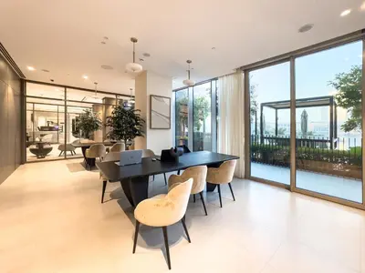 a dining room with a table and chairs and large windows at Premium 1 BDR, In Burj Khalifa Park, Dubai Mall Walking Distance , Opera House 1mn away in Dubai