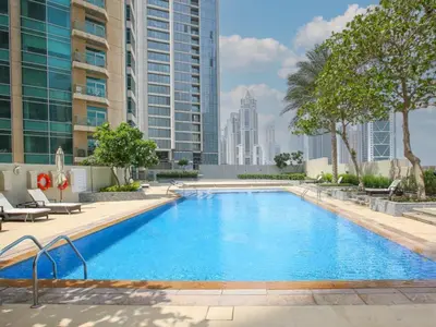 a large swimming pool in a building with tall buildings at Elegant 2 Bed Downtown Duplex - Prime Location in Dubai
