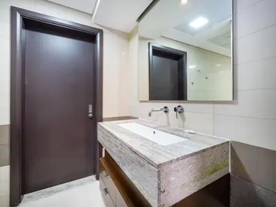 a bathroom with a sink and a large mirror at Elegant 2 Bed Downtown Duplex - Prime Location in Dubai