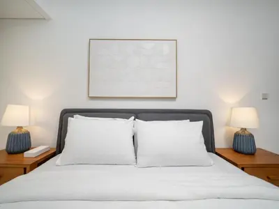 a bedroom with a bed with two lamps on tables at Elegant 2 Bed Downtown Duplex - Prime Location in Dubai