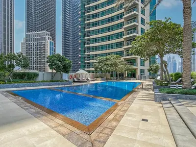 a swimming pool in a city with tall buildings at Elegant 2 Bed Downtown Duplex - Prime Location in Dubai
