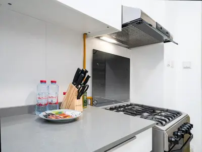 a kitchen with a stove and a bowl on a counter at Bright JVC Studio - Serenity Escape in Dubai