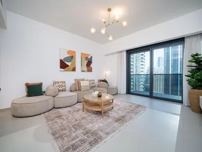 a living room with a couch and a table at Luxury Downtown 3 Bed with Full Burj Khalifa Views in Dubai