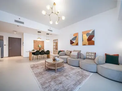 a living room with a couch and a table at Luxury Downtown 3 Bed with Full Burj Khalifa Views in Dubai