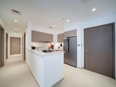 a kitchen with a white counter and a refrigerator at Luxury Downtown 3 Bed with Full Burj Khalifa Views in Dubai