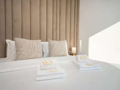 a bedroom with a bed with two pillows on it at Luxury Downtown 3 Bed with Full Burj Khalifa Views in Dubai