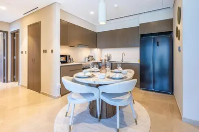 a kitchen and dining room with a table and chairs at New 2 Bedroom apartment overlooking Burj Khalifa and fountain view in downtown in Dubai