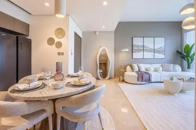 a living room with a table and a couch at New 2 Bedroom apartment overlooking Burj Khalifa and fountain view in downtown in Dubai