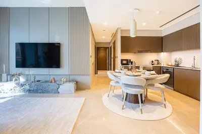 a kitchen and dining room with a table and a tub at New 2 Bedroom apartment overlooking Burj Khalifa and fountain view in downtown in Dubai