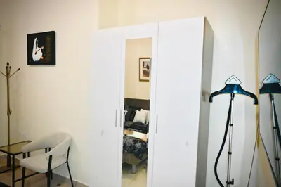 a room with a chair and a table and a mirror at Marina Breeze Residence Near to Yachts and Beach in Dubai