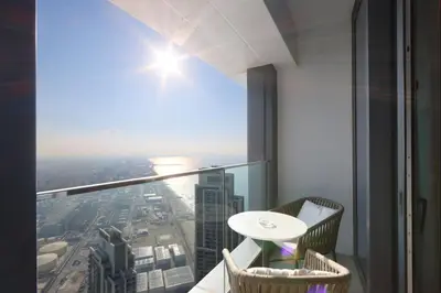 a room with a table and a view of a city at Stunning 1BR with Marina View And Beach Access in Dubai