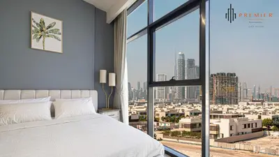 a bedroom with a large window with a city view at PREMIER 1BR - Burj Khalifa View in Dubai