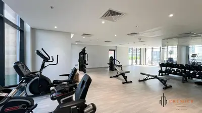 a gym with several treadmills and cardio machines at PREMIER 1BR - Burj Khalifa View in Dubai