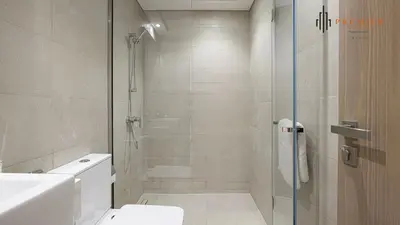 a bathroom with a shower and a toilet at PREMIER 1BR - Burj Khalifa View in Dubai