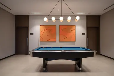 a pool table in a room with art on the wall at Arthouse Grande Signature - 2 BR with Full Burj Khalifa and Fountain View in Dubai