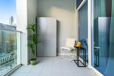 a balcony with a chair and a table in a building at Elegant 2 Bedroom in Business Bay with Burj View in Dubai