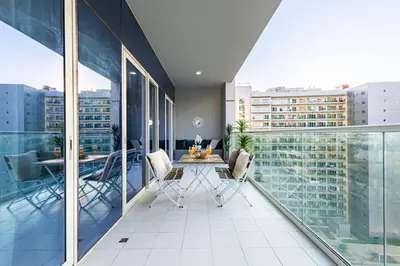 a balcony with a table and chairs on a building at Elegant 2 Bedroom in Business Bay with Burj View in Dubai