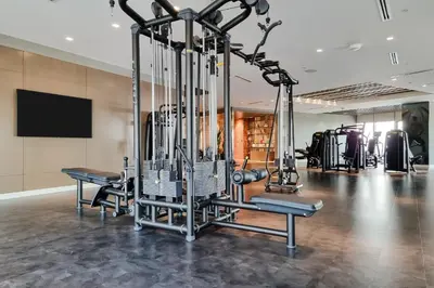 a gym with several tread machines in a room at Paramount Midtown by Luxe Living in Dubai