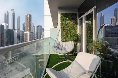 a balcony with chairs and a view of the city at Burj Khalifa View 1 Bedroom Apartment With Balcony For Up To 4 Person in Dubai