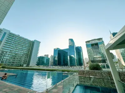 a pool in the middle of a city with tall buildings at Burj Khalifa View 1 Bedroom Apartment With Balcony For Up To 4 Person in Dubai