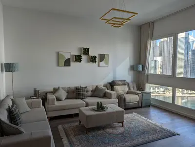 a living room with a couch and a table at Stunning 2BR Apartment with Full Marina View in Dubai