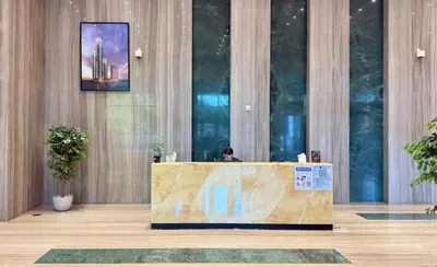 a person sitting at a desk in a lobby at Canal-View Duplex in Dubai