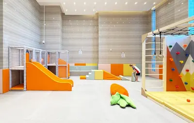 a childrens play room with a climbing wall and a slide at Canal-View Duplex in Dubai