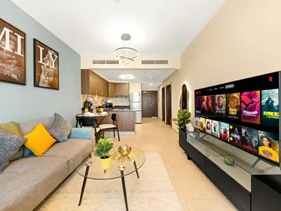 a living room with a couch and a table at Iconic Palm & Sea Views on 58th Floor Skyline Apt in Dubai