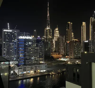 a view of a city skyline at night at Luxury 2BR Burj View & Jacuzzi in Dubai