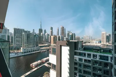 a view of a city with a river and buildings at Luxury 2BR Burj View & Jacuzzi in Dubai