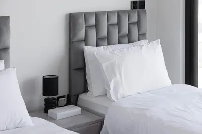 a bedroom with a large bed with white pillows at Luxury 2BR Burj View & Jacuzzi in Dubai